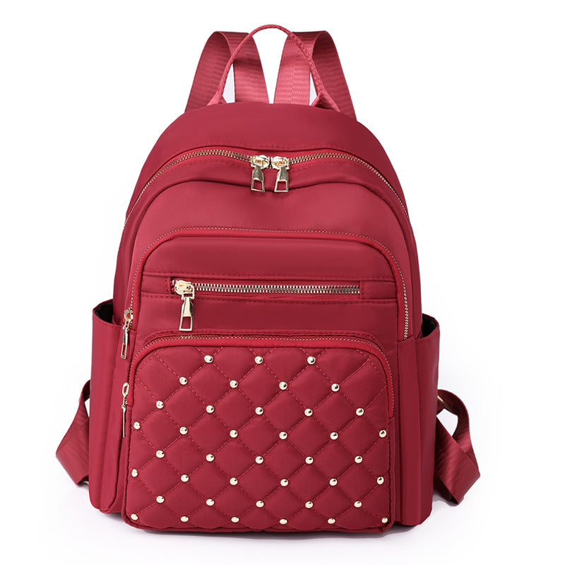 Solid color rhombus sewing line rivets fashion backpack women's 2025 texture Korean version large capacity simple women's backpack