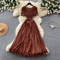 Sophisticated and elegant green pleated dress for women. short-sleeved, waist-cinching, pleated maxi dress, perfect for the office or a sophisticated socialite look