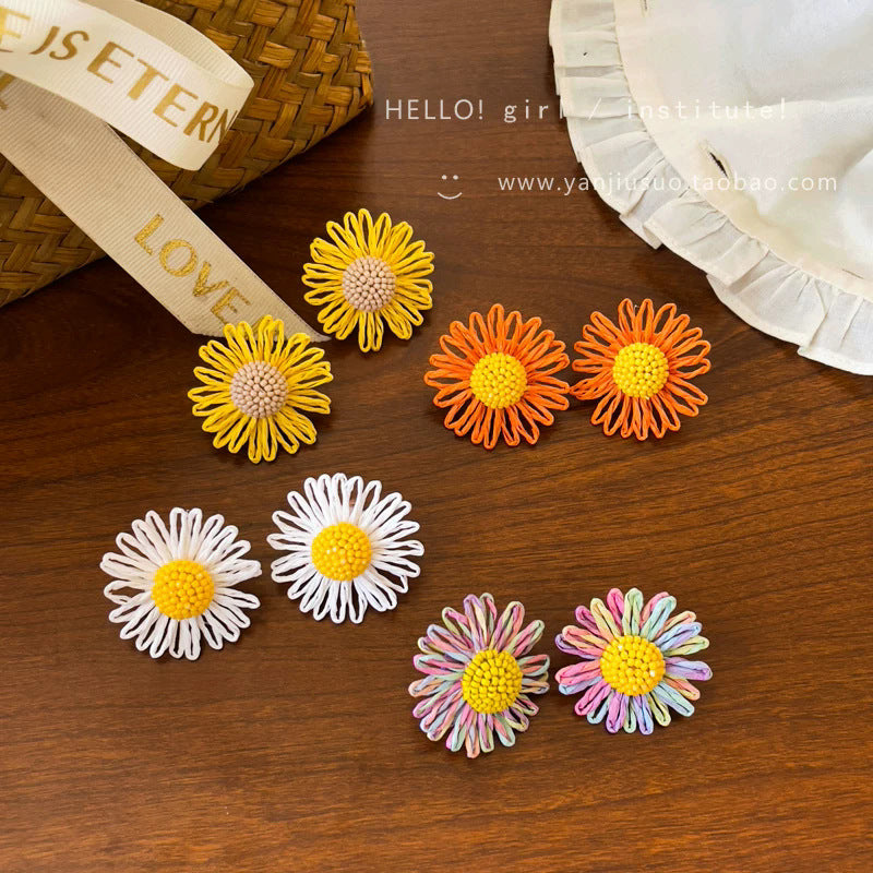 Milky soft, woven raffia daisy flower earrings for women. statement beach earrings designed to flatter the face with a touch of high-end elegance