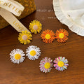Milky soft, woven raffia daisy flower earrings for women. statement beach earrings designed to flatter the face with a touch of high-end elegance
