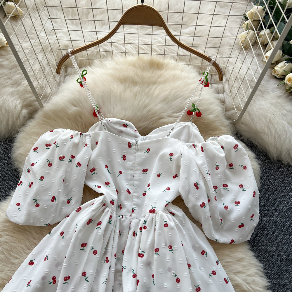 spring/summer sweet one-shoulder cami dress with bubble short sleeves, cherry print, cinched waist, and ruffle hem