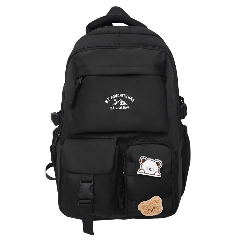 Minimalist korean style fashion casual backpack for high school and college students, featuring cute cartoon badges and large capacity