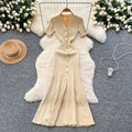 Elegant and sophisticated v-neck short-sleeve knit dress for women, perfect for summer. features a slimming, single-breasted design with a slit and shimmering silk details. a long, chic sweater dress
