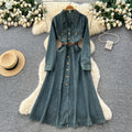 French retro chic, high-end denim dress with metal buckle collar, long sleeves, single-breasted button closure, and tie-waist detail
