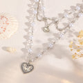 Wholesale faux pearl chains: cross-border fashion, niche, high-end, gothic style heart pendant necklace, sweater chain accessories