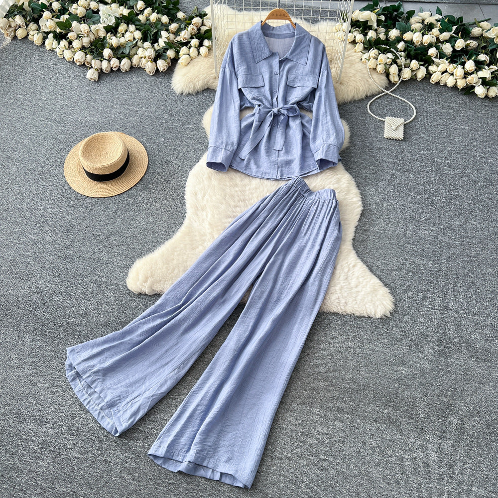 Sophisticated, niche design two-piece set for women: a long-sleeved, tie-waist blouse with a bow detail, paired with high-waisted, wide-leg pants