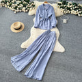 Sophisticated, niche design two-piece set for women: a long-sleeved, tie-waist blouse with a bow detail, paired with high-waisted, wide-leg pants
