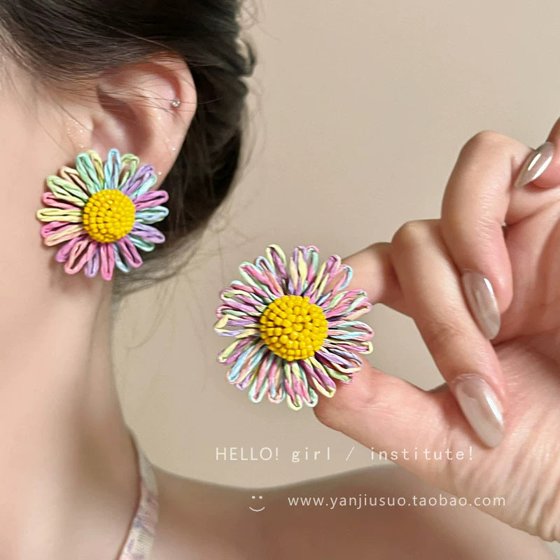 Milky soft, woven raffia daisy flower earrings for women. statement beach earrings designed to flatter the face with a touch of high-end elegance