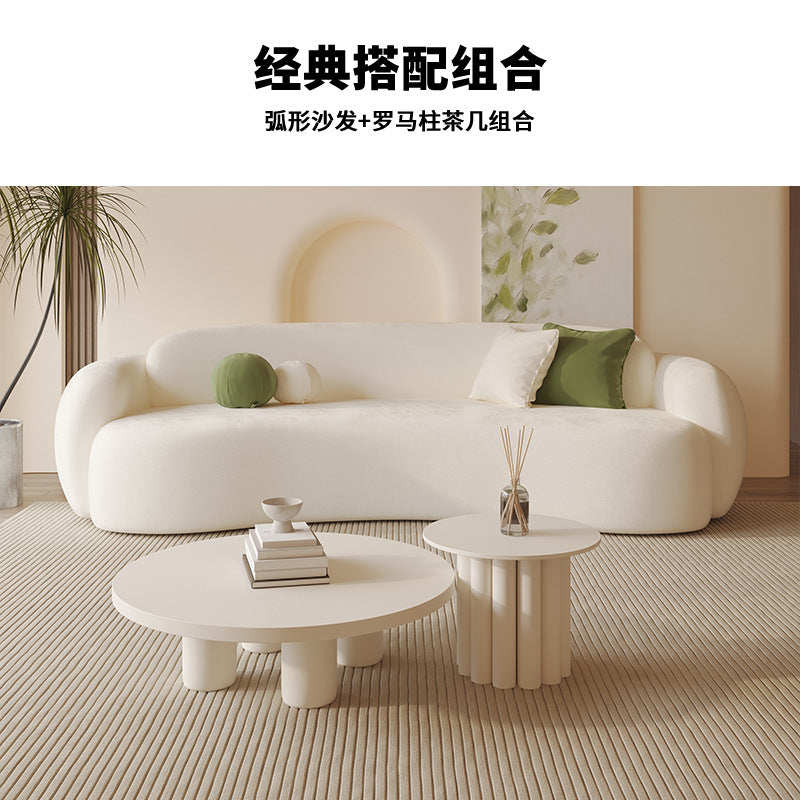Curved, uniquely shaped, cream-toned sofa – a creative and sophisticated addition to clothing stores, beauty salons, office break rooms, and reception areas