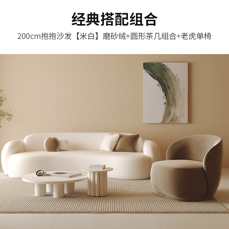 Curved, uniquely shaped, cream-toned sofa – a creative and sophisticated addition to clothing stores, beauty salons, office break rooms, and reception areas