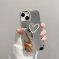 Mirror-finish apple 16 pro silver bowknot phone case, iphone 15/12 compatible, anti-drop hard protective case with wrist strap
