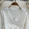 Elegant chanel-inspired v-neck double-breasted knit dress with cinched waist – a chic and sophisticated layering piece for spring and autumn