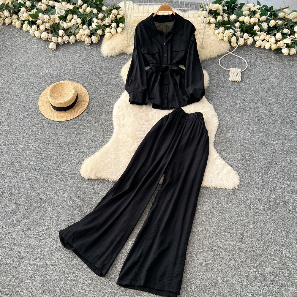 Sophisticated, niche design two-piece set for women: a long-sleeved, tie-waist blouse with a bow detail, paired with high-waisted, wide-leg pants