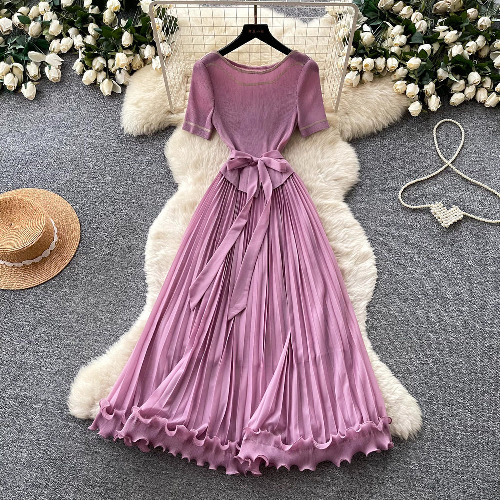 Sophisticated and elegant green pleated dress for women. short-sleeved, waist-cinching, pleated maxi dress, perfect for the office or a sophisticated socialite look