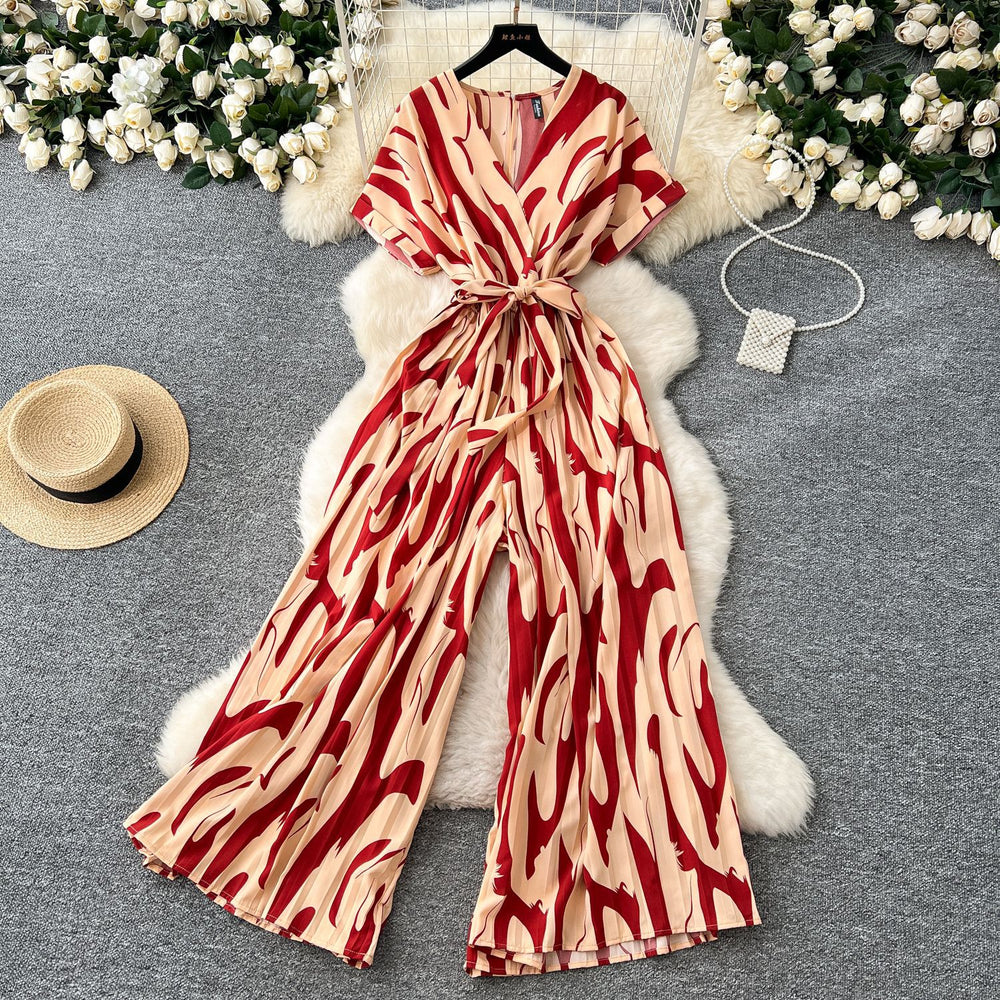 Fashion ins style vacation beach pants women's new style light mature niche stylev neck short sleeve strap looseprinting jumpsuit