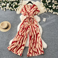 Fashion ins style vacation beach pants women's new style light mature niche stylev neck short sleeve strap looseprinting jumpsuit