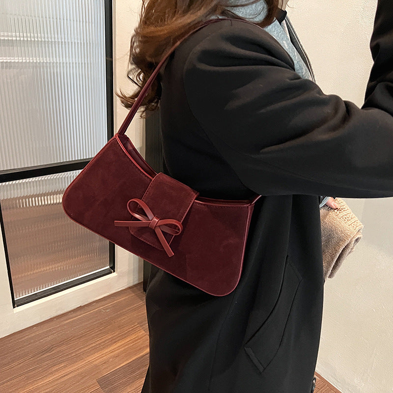 Red bag women's bag 2025 new shoulder baguette bag Korean version fashion minimalist niche bow armpit bag