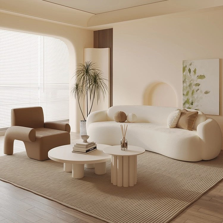 Curved, uniquely shaped, cream-toned sofa – a creative and sophisticated addition to clothing stores, beauty salons, office break rooms, and reception areas