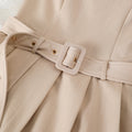Women's sleeveless pleated mini dress with cinched waist, round neck, and belt – a chic and versatile work-ready style