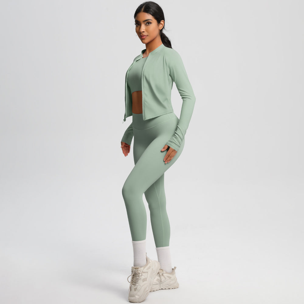 High-waisted, form-fitting yoga pants, a barely-there feel, quick-drying outer layer, and a long-sleeved tee – a women's three-piece activewear set perfect for running and workouts