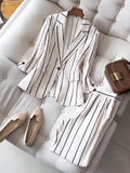 elegant vertical striped commute set: notch lapel blazer with cinched waist, paired with high-waisted, drapey wide-leg trousers for women