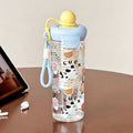 Trendy summer water bottle for girls: high-style, large capacity, tea infuser, straw cup with cute cartoon float – made of plastic