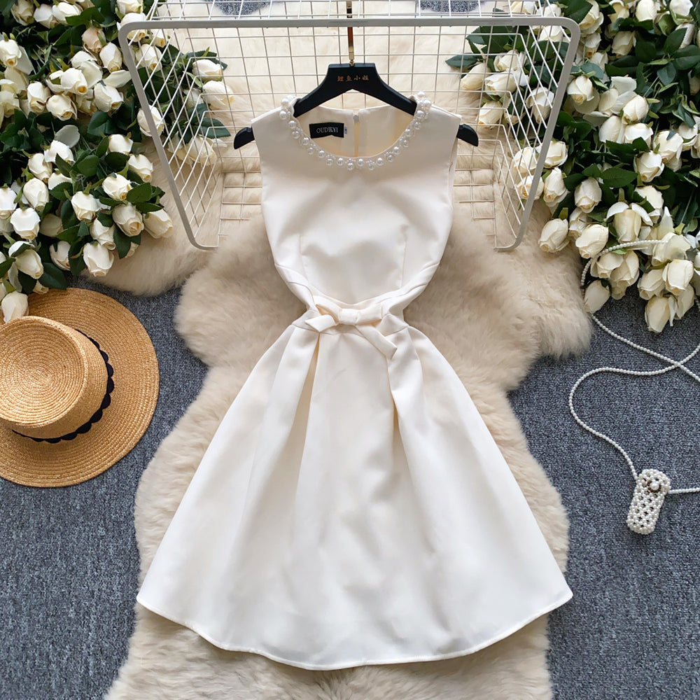 High-end, understated luxury beaded round neck sleeveless dress for women. perfect for summer, this french-inspired dress features a cinched waist, a-line silhouette, and a flattering, voluminous skirt. ideal as an elegant evening gown or special occasion