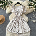 French chic polka dot dress - effortless summer style: square neck, cinched waist, slimming a-line for petite figures