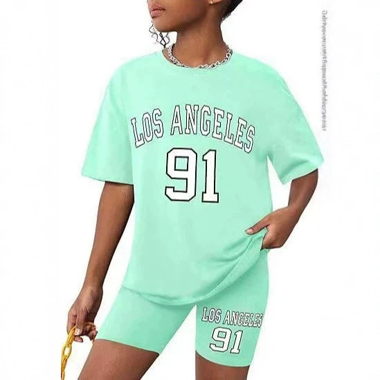 Girls' t-shirt and shorts set featuring a cartoon short-sleeve design and printed graphics, perfect for casual streetwear