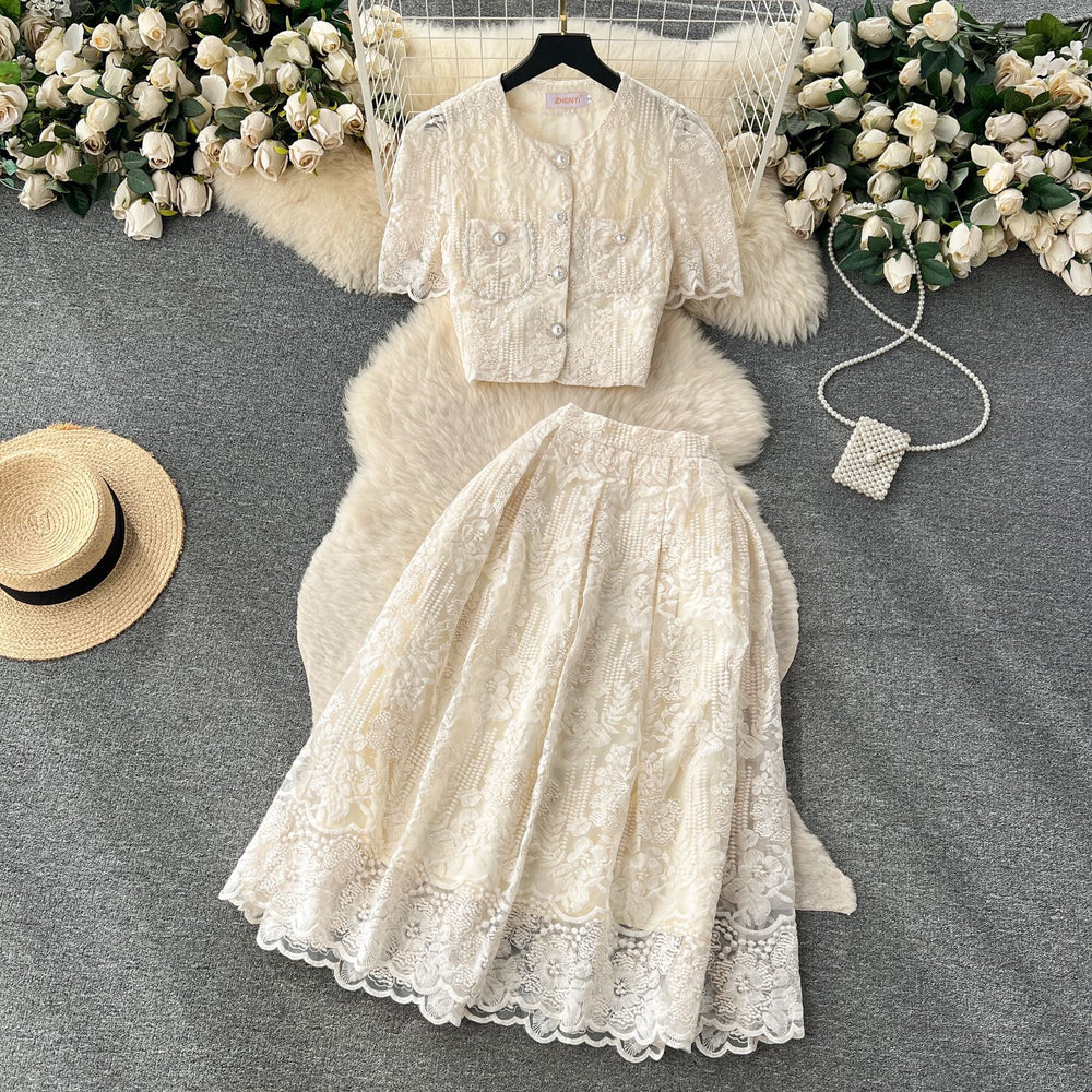 High-end, sophisticated, and feminine two-piece set for women. features a french-style lace crochet blouse with puff sleeves and a high-waisted, slimming midi skirt