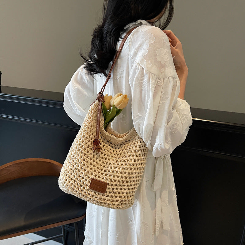 Holiday knitted bag women's 2025 summer new commuter shoulder messenger bag hollow woven bucket bag wholesale