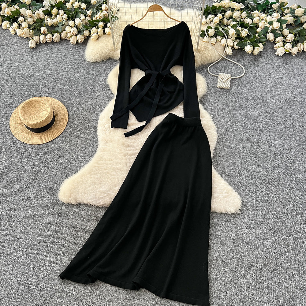 French chic autumn/winter outfit: asymmetrical tie-waist long sleeve knit top + high-waisted midi skirt