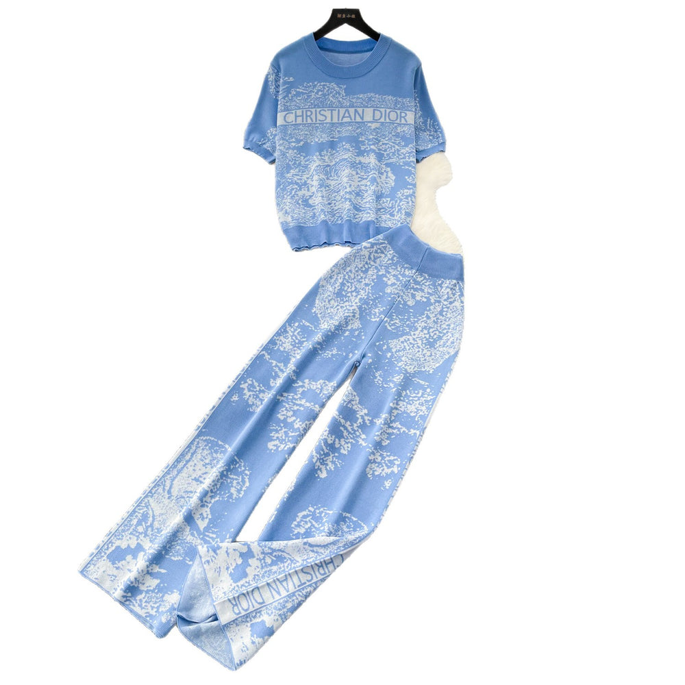 Vacation-ready pink floral print letter print casual two-piece set for women, featuring a summer short-sleeved top and high-waisted wide-leg pants. a stylish and versatile outfit perfect for both work and play