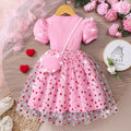 Girls' ribbed knit dress with heart-shaped mesh sleeves and pearl accents, includes crossbody bag