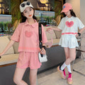 new girls' summer outfit set: stylish and trendy, perfect for older girls. summer-inspired short-sleeve and shorts set with heart-themed polo shirt – a popular choice for kids' summer fashion