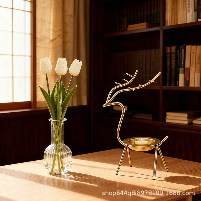 French-chic holiday decorations: deer and elk shaped iron candle holders, golden decorative pieces for restaurant tabletops