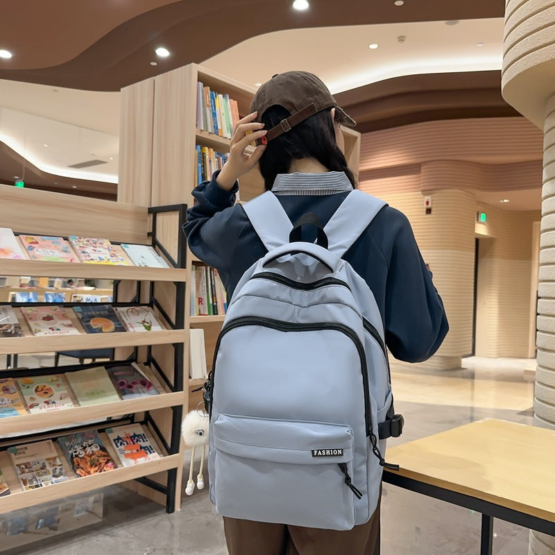 Large capacity burden reduction solid color backpack male junior high school student primary school bag female simple versatile travel backpack