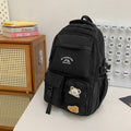 Minimalist korean style fashion casual backpack for high school and college students, featuring cute cartoon badges and large capacity