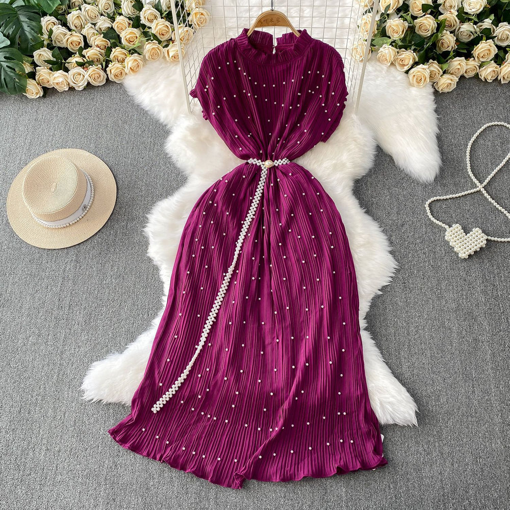Elegant and sophisticated, this heavy-beaded, ruffled-edge, round-neck dress is a stunning new addition to your summer wardrobe. designed to flatter, it features a cinched waist and a slimming silhouette, finished with a pleated maxi skirt