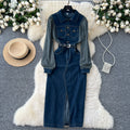 French-inspired, niche long-sleeved striped denim dress with a collared neckline, metal button detailing, a fitted waist, and a stylish slit