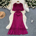Elegant and alluring, this high-end, figure-hugging, mid-length mermaid gown features a plunging neckline, short sleeves, hot-fix rhinestone embellishments, and a daring slit. perfect for the sophisticated woman