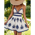 Women's white and blue floral print cami dress with v-neck, cinched waist, and cutout detail – perfect for a fresh and casual summer vacation look