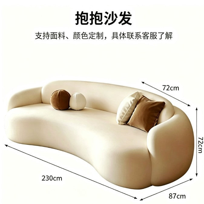Curved, uniquely shaped, cream-toned sofa – a creative and sophisticated addition to clothing stores, beauty salons, office break rooms, and reception areas