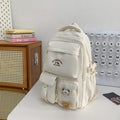 Minimalist korean style fashion casual backpack for high school and college students, featuring cute cartoon badges and large capacity