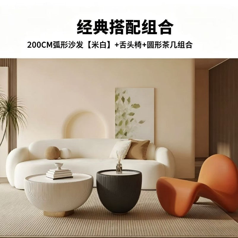 Curved, uniquely shaped, cream-toned sofa – a creative and sophisticated addition to clothing stores, beauty salons, office break rooms, and reception areas