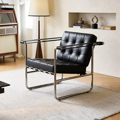Vintage-inspired minimalist black leather and stainless steel sofa chair, designer piece for home living rooms, casual armchair with backrest