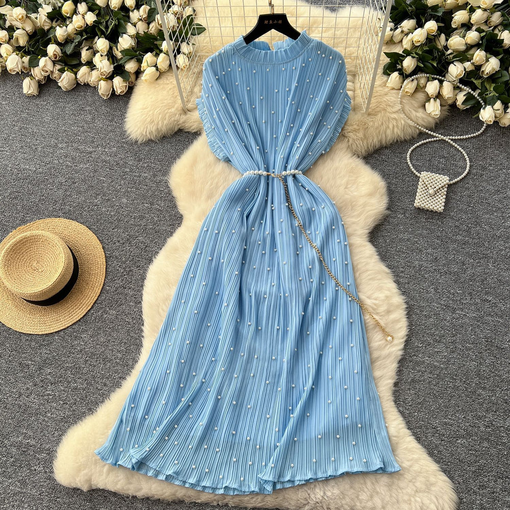 French-inspired v-neck floral chiffon dress with flared sleeves, tie waist, and a figure-flattering, vintage-inspired silhouette