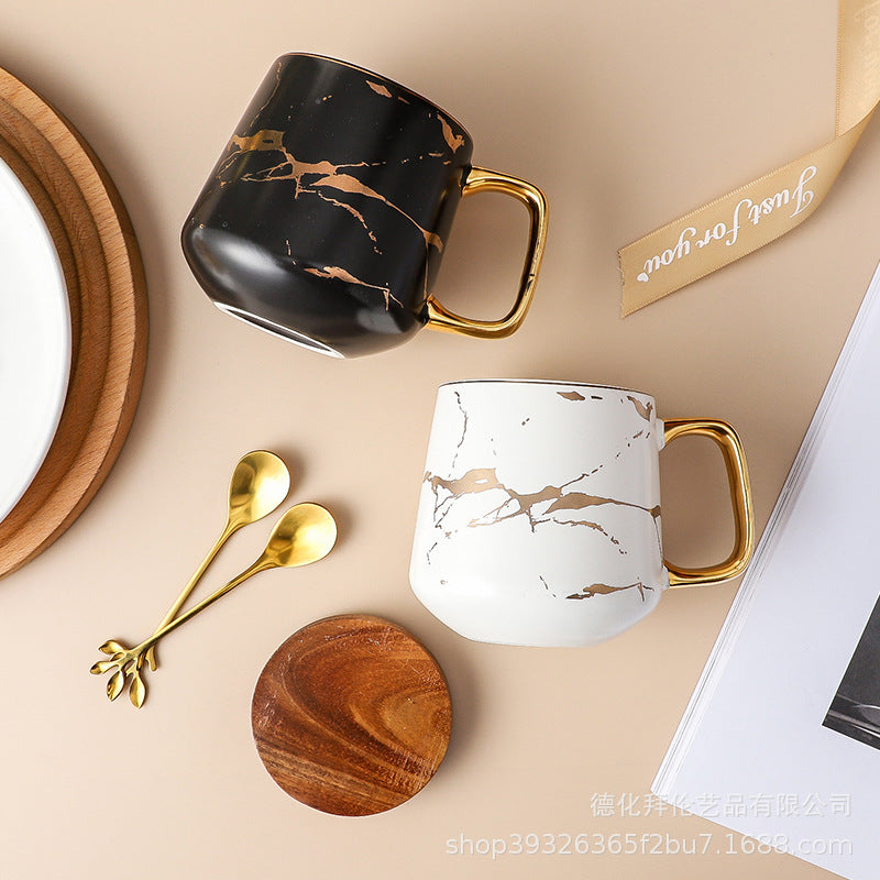 Nordic-inspired ceramic coffee mug, teacup, and saucer set with gold-traced marble pattern and wooden lid