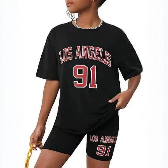 Girls' t-shirt and shorts set featuring a cartoon short-sleeve design and printed graphics, perfect for casual streetwear
