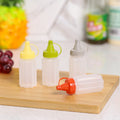 Four-piece seasoning set: transparent sauce dispenser bottles for outdoor bbq, kitchen spice jars, and condiment containers